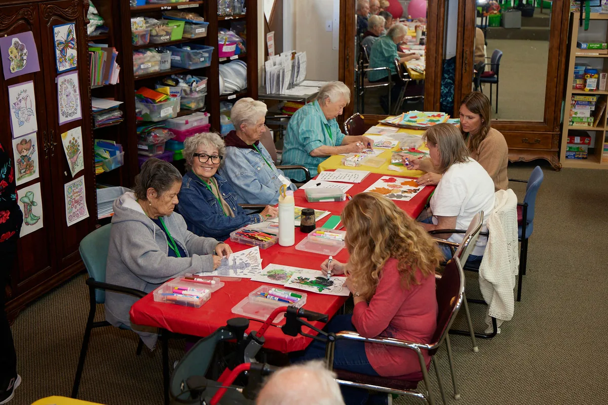 Participants and staff work on arts and crafts together at Aspen Senior Day Center