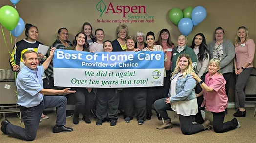 Seniors and staff sharing an activity at Aspen Senior Day Center