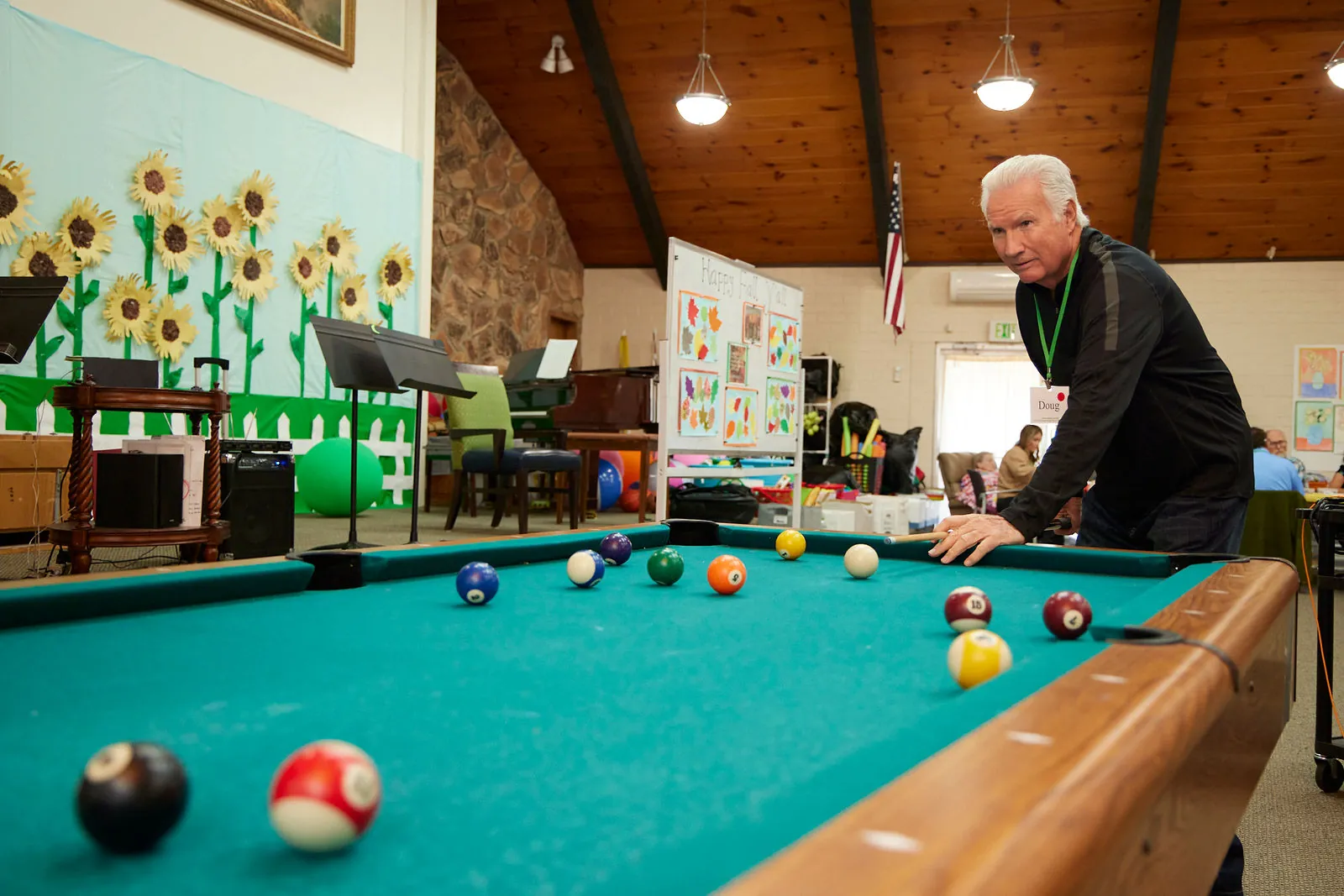 A participant lines up a shot at the pool table in Aspen Senior Day Center’s activity room